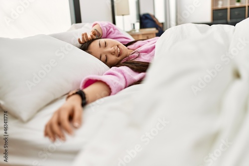 Young chinese girl sleeping on the bed at bedroom.
