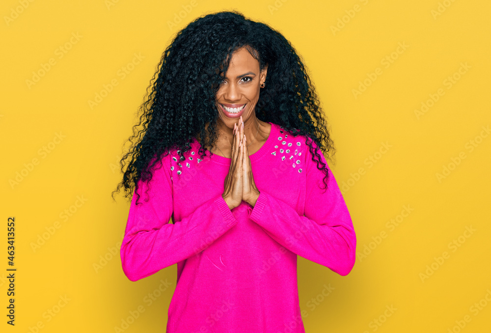Middle age african american woman wearing casual clothes praying with hands together asking for forgiveness smiling confident. Middle age african american woman wearing casual clothes praying with hands together asking for forgiveness smiling confident.