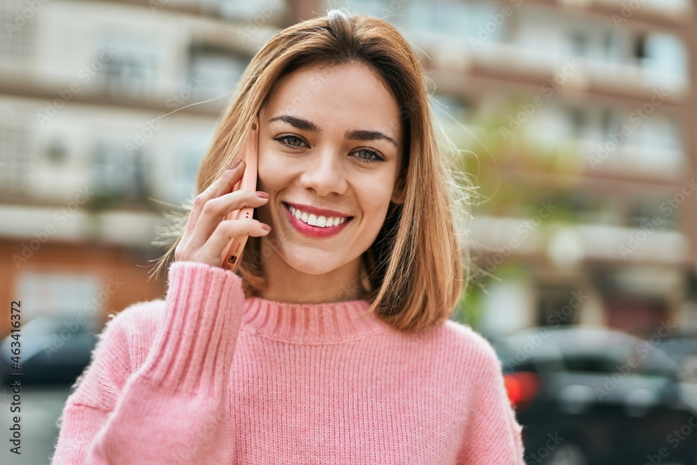 Young caucasian girl smiling happy talking on the smartphone at the city. Young caucasian girl smiling happy talking on the smartphone at the city.