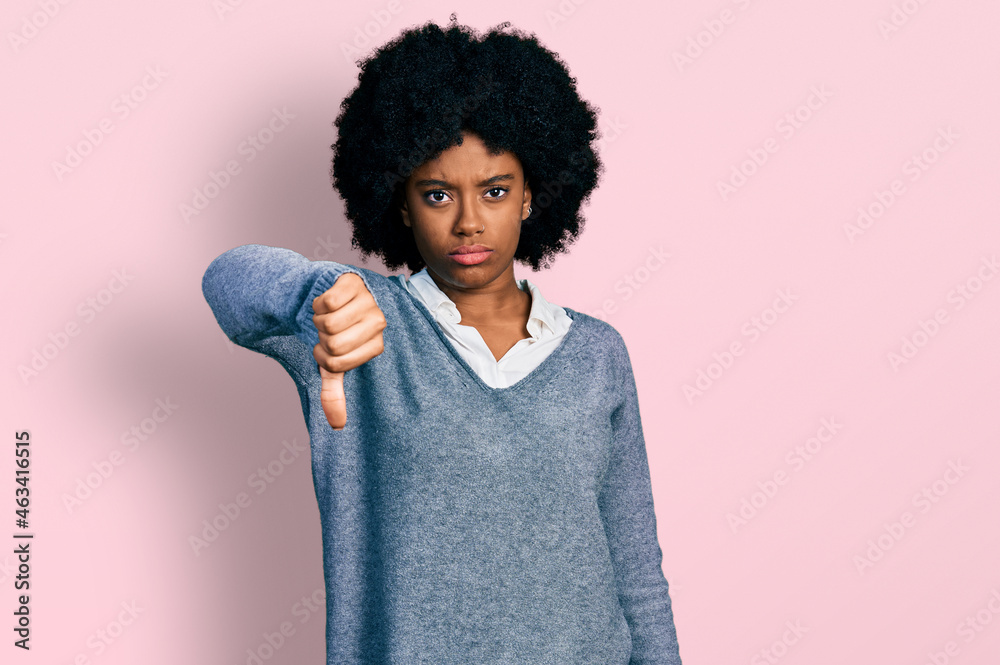 Young african american woman wearing business clothes looking unhappy and angry showing rejection and negative with thumbs down gesture. bad expression. Young african american woman wearing business clothes looking unhappy and angry showing rejection and negative with thumbs down gesture. bad expression.
