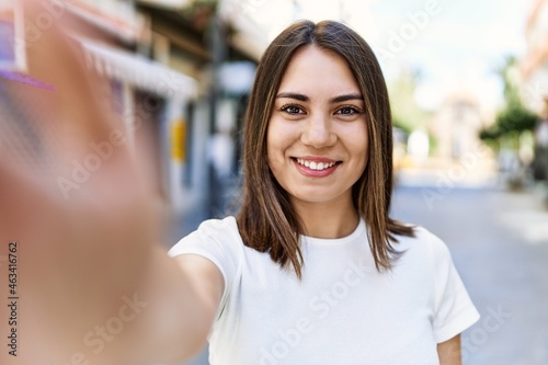 Young beautiful woman smiling happy outdoors on a sunny day of summer taking a selfie picture Free Download Young beautiful woman smiling happy outdoors on a sunny day of summer taking a selfie picture - GFXLoad