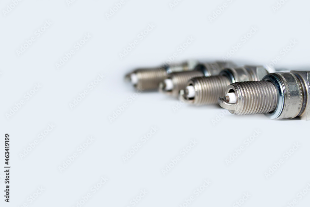 spark plugs on white background with copy space and reflection. auto spare parts on white background spark plugs on white background with copy space and reflection. auto spare parts on white background