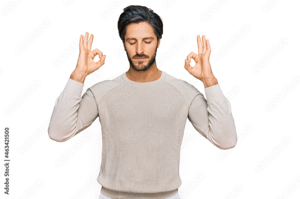 Young hispanic man wearing casual clothes relax and smiling with eyes closed doing meditation gesture with fingers. yoga concept. Young hispanic man wearing casual clothes relax and smiling with eyes closed doing meditation gesture with fingers. yoga concept.