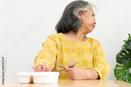 Unhappy Asian senior woman anorexia and say no to ready meals, Elderly home alon Fototapeta