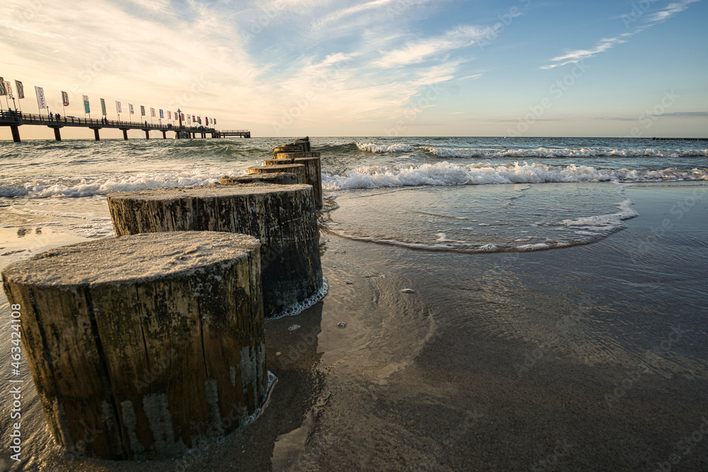 on the coast of the baltic sea on zingst. the pier and groynes that go into the water.