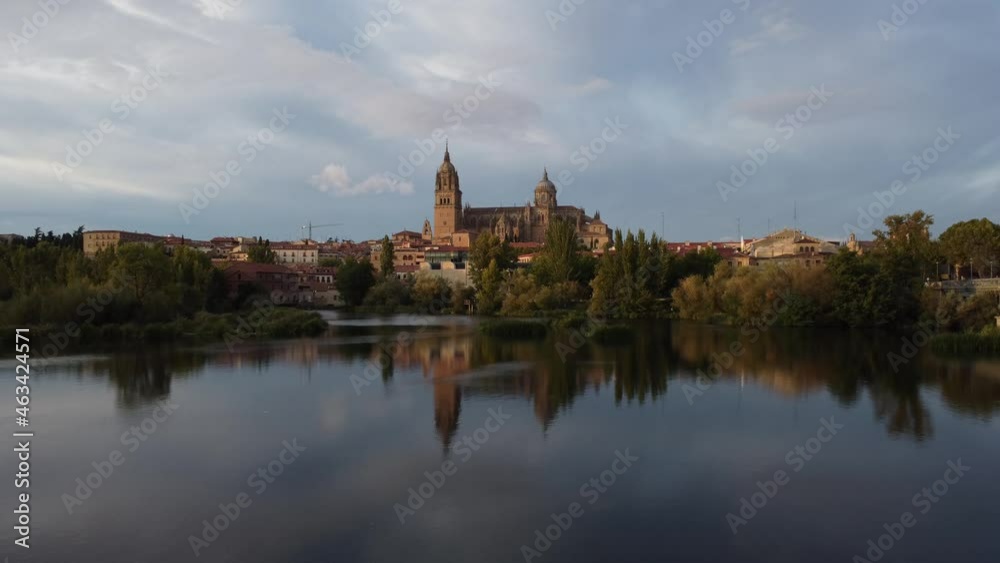 View of the Salamanca cathedral reflected in the Tormes river in Spain.