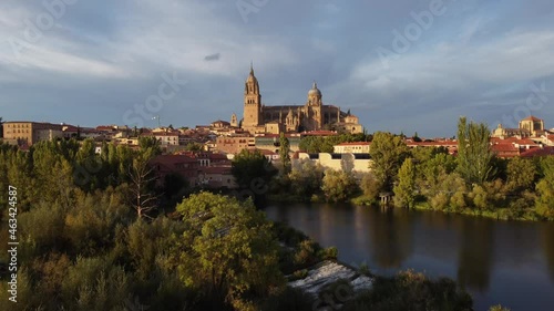 View of the Salamanca cathedral reflected in the Tormes river in Spain. photo