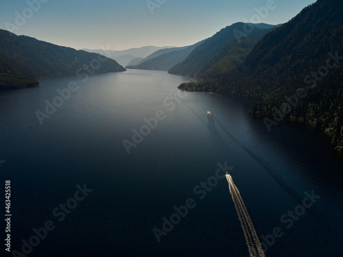 Motor boat moored to the shore of a mountain lake. Russia, Altai Republic, Ulagansky district, Lake Teletskoye, tract Cordon Chiri photo