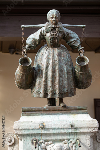 Figure of a woman in a Bamberg costume, with a carrier and conches. (Bamberka) Old town Poznan, Poland.
