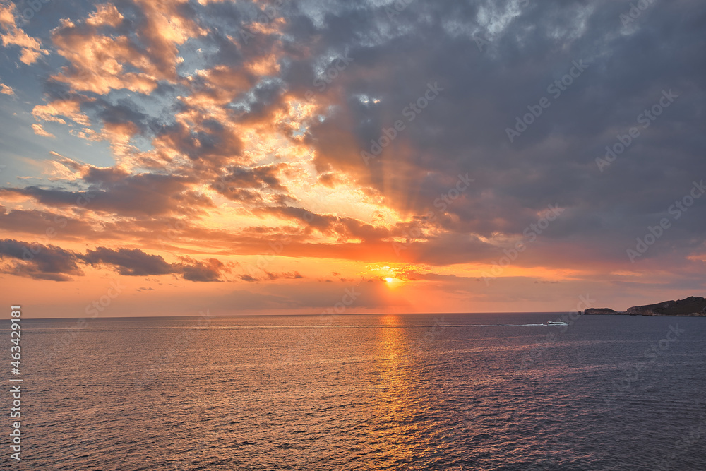 Beautiful sunset with a dramatic sky and clouds over the sea