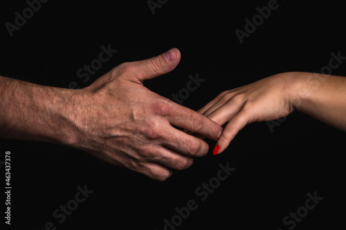 A man's hand catching a woman's hand