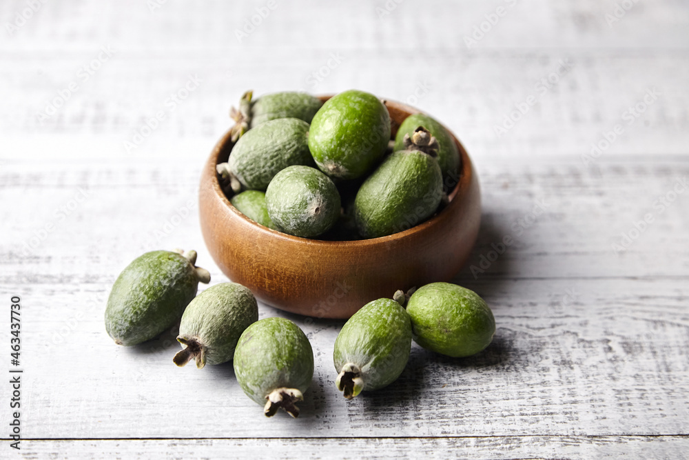 Feijoa fruits or pineapple guava in bowl on wooden table Feijoa fruits or pineapple guava in bowl on wooden table