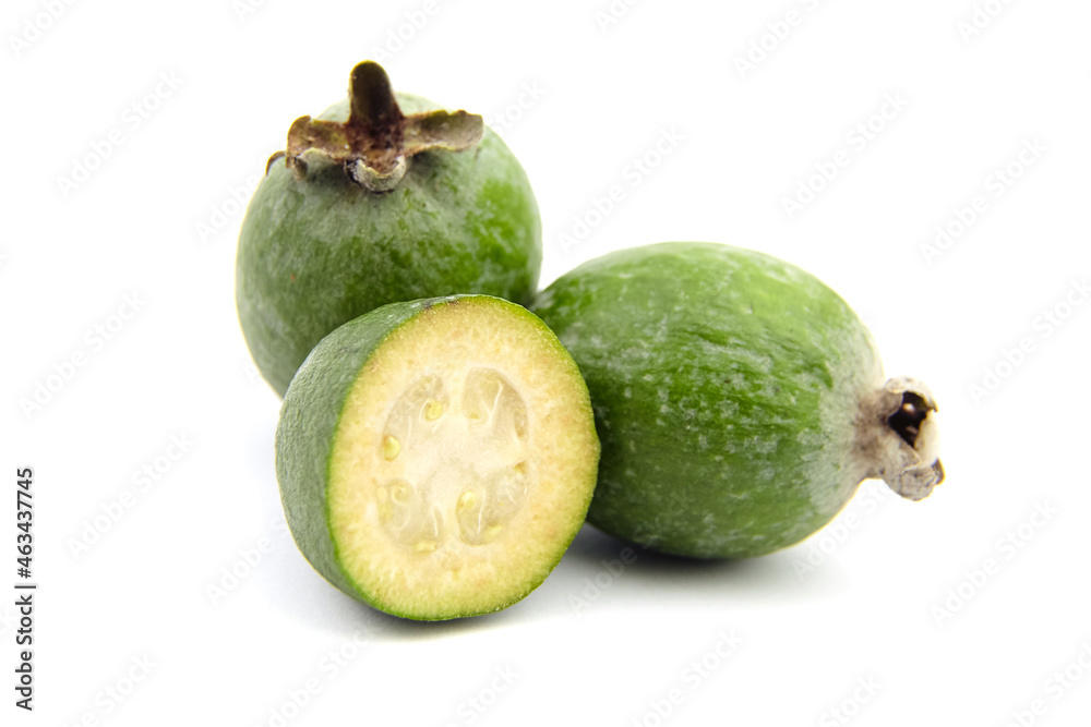 Feijoa fruit or whole and half pineapple guava isolated on white Feijoa fruit or whole and half pineapple guava isolated on white