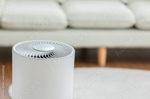 Close up Air purifier in cozy white living room for filter and cleaning removing dust PM2.5 HEPA and virus in home,for fresh air and healthy Wellness life,Air Pollution Concept