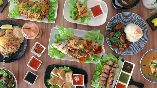 Male hand arranging soy sauce condiments on flat lay arrangement. photo