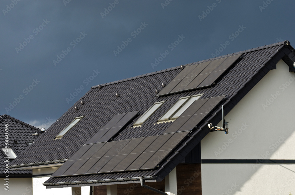 Fototapeta premium Solar panels on roof of private house on cloudy day