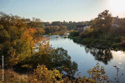 View from the hill on the autumn bank of the river. Autumn landscape colors.