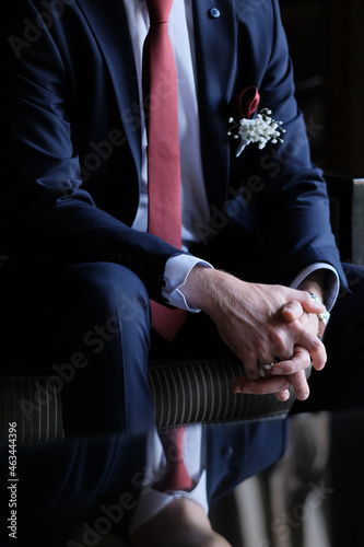 businessman at a party, his hands reflected from the table