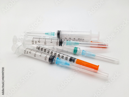 Several syringes in a group. Close up. Could be used to symbolize needle exchange, innoculation or other medical activities. photo