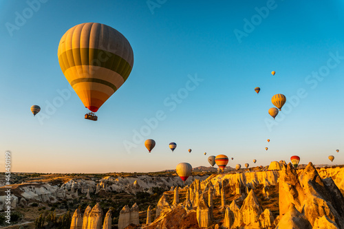 Shot of colorful hot air balloons flying over Goreme national park in Nevsehir, Cappadocia, Turkey photo