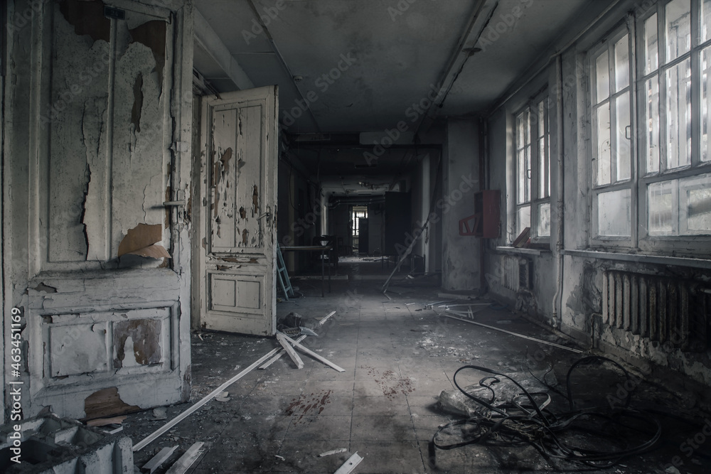 Scary empty dark corridor in an abandoned building. Shabby walls. The play of light and shadows in an abandoned house. Broken doors. An old abandoned hospital. The interior of an abandoned house. Scary empty dark corridor in an abandoned building. Shabby walls. The play of light and shadows in an abandoned house. Broken doors. An old abandoned hospital. The interior of an abandoned house.