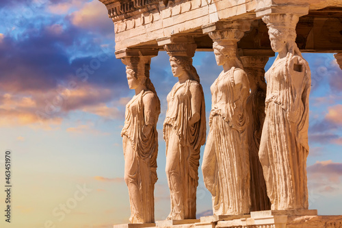 Detail of Caryatid Porch on the Acropolis uring colorful sunset in Athens, Greece. Ancient Erechtheion or Erechtheum temple. World famous landmark at the Acropolis Hill. photo