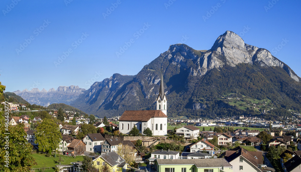 Parish Church of St. Anthony at the st. Gallen town Wangs with Sargans, Mont Gonzen and the Churfirst mountain range at the background. The town is the starting point for Pizol trekking trails.