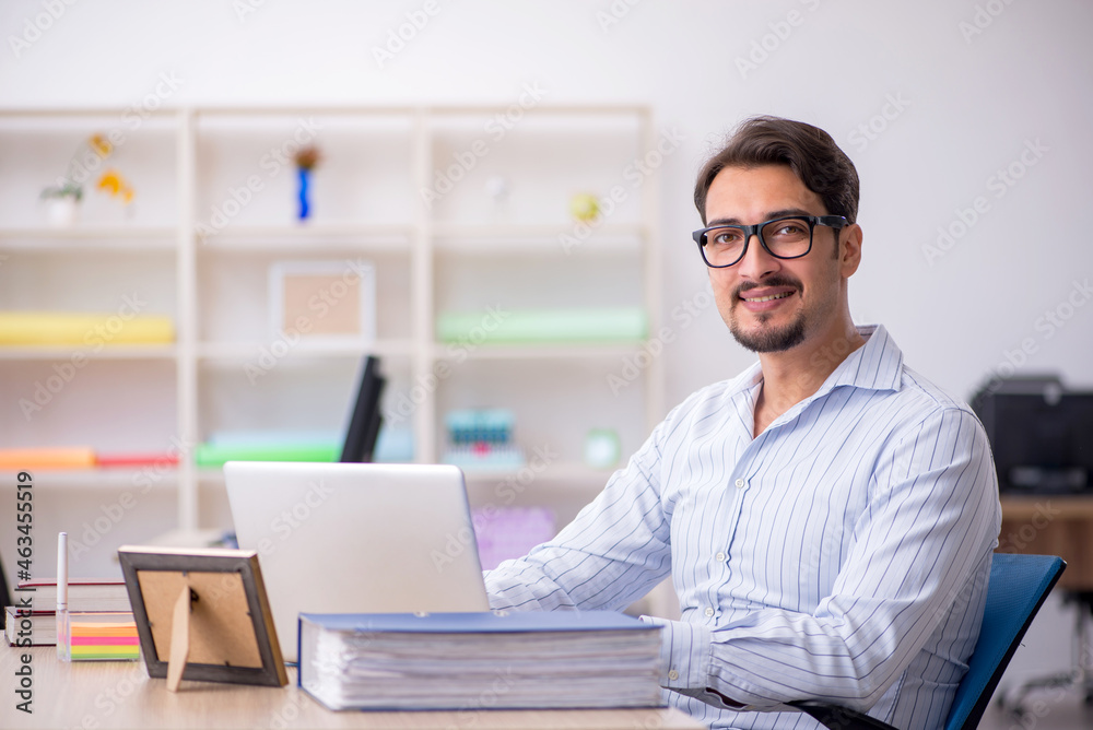 Young male employee working in the office Young male employee working in the office