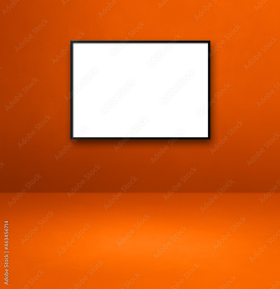Black picture frame hanging on an orange wall Black picture frame hanging on an orange wall