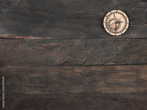 wooden clock on old wooden background