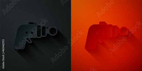 Paper cut Ray gun icon isolated on black and red background. Laser weapon. Space blaster. Paper art style. Vector