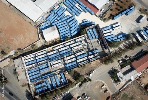 Aerial drone top view of abandoned transport Blue buses parking. shabby and broken vehicle. Junkyard of buses Cyprus