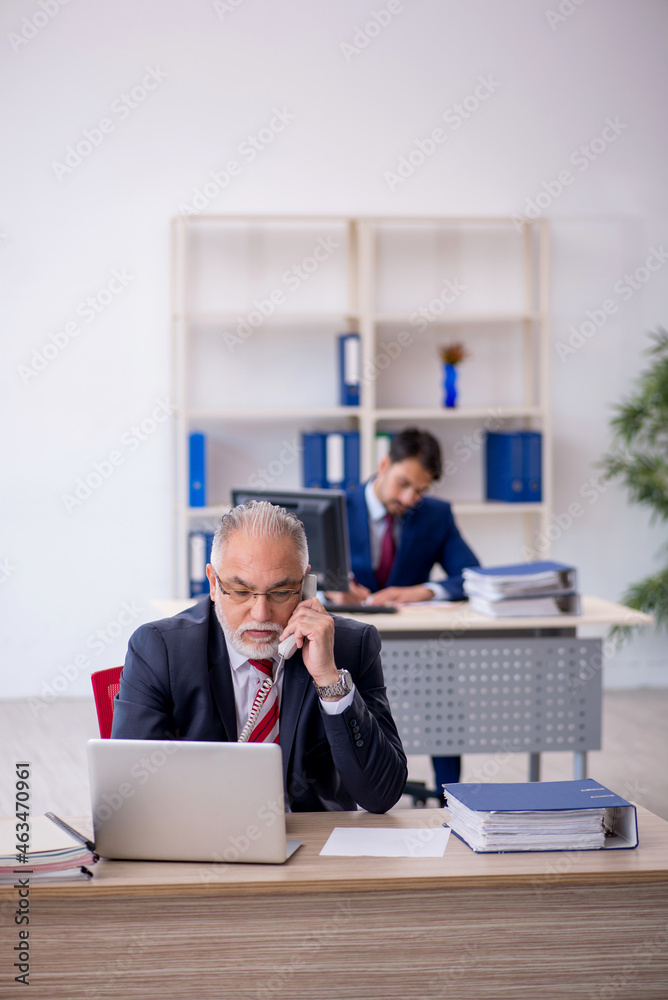 Two male colleagues working in the office Two male colleagues working in the office