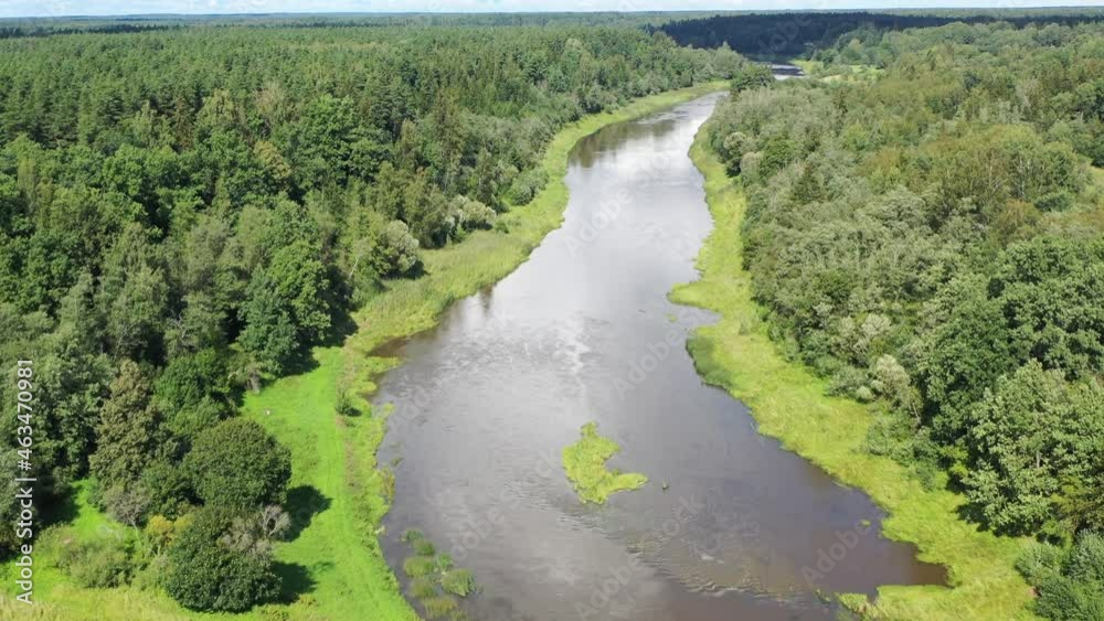 Aerial shot flying along river. River sorrounded by green forest Aerial shot flying along river. River sorrounded by green forest