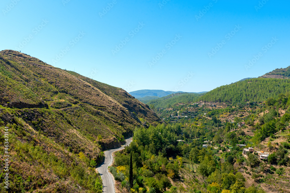 An old asphalt road through a valley from above in southern Turkey.