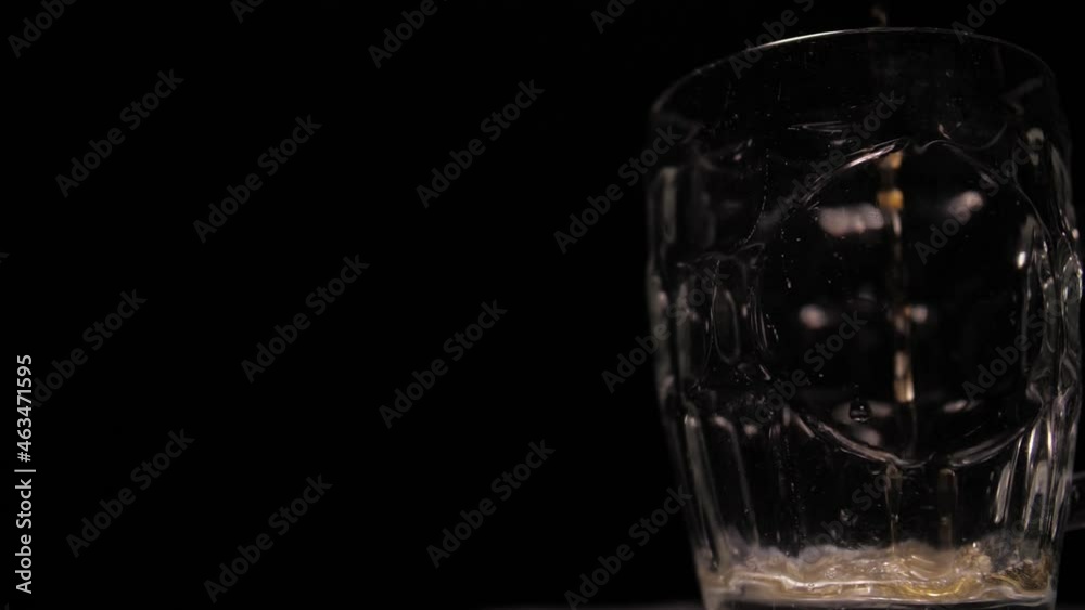 pouring beer into a glass mug slow motion