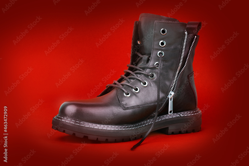 Black boots isolated on red bacground