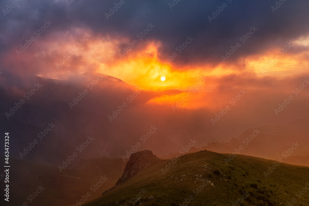 Mountain dramatic sunset in clouds