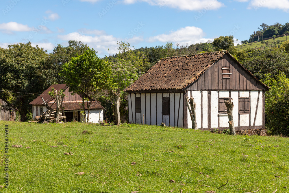 Farm field with old house in german style