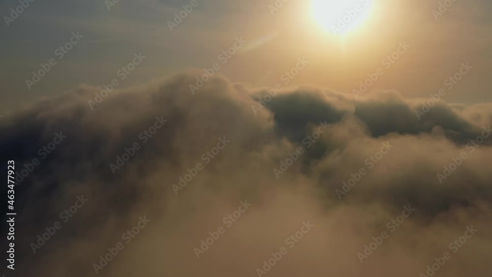 Sun is rising above the endless sea of clouds until the horizon. Amazing nature landscape, 4K drone in sky. Aerial View of Flying Over Clouds at Sunrise. fog dawn