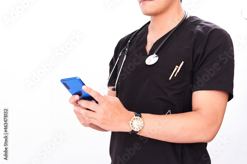 doctor young latino male doctor on white background typing a message on his cell phone, model not recognizable