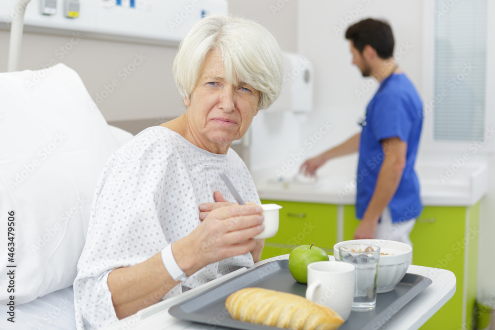 © auremar - senior woman in hospital disliking the medical center meal