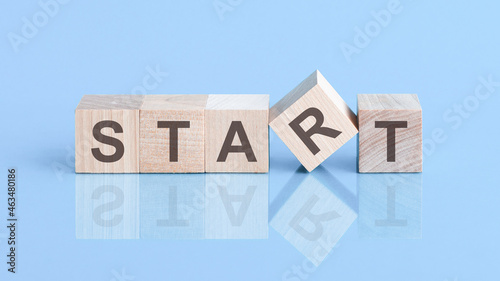 Wooden blocks with words 'START' on beautiful blue background, copy space. Business concept.