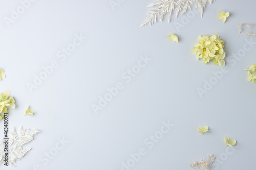 Cosmetic background with flowers on grey. Flat lay, copy space © luckyshoe