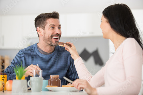 young happy couple having breakfast together