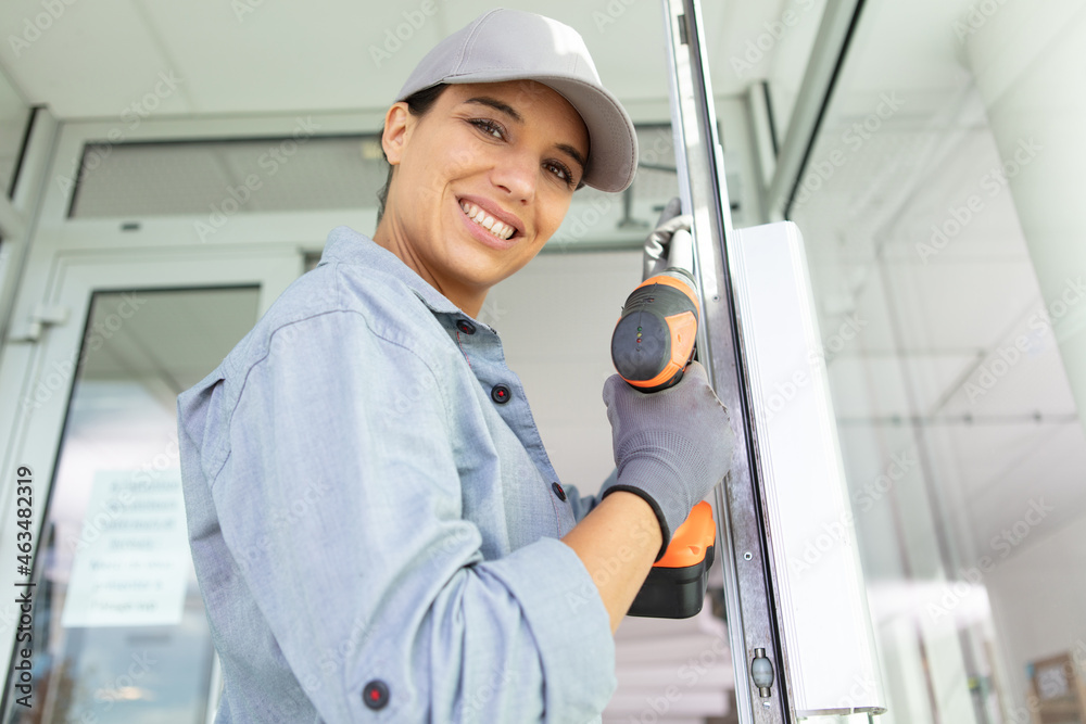 female carpenter using electric drill in workshop female carpenter using electric drill in workshop