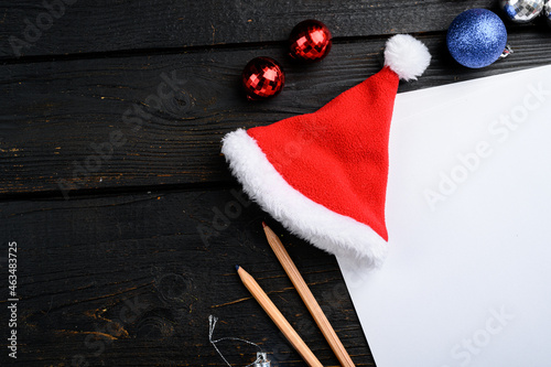 Empty paper blank with Christmas tree decoration, top view flat lay , with copy space for text , on black wooden table background