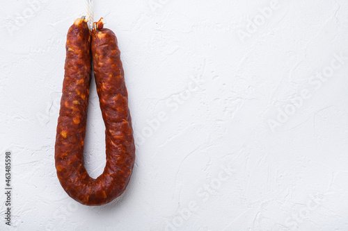 Spanish chorizo sausage on white background, topview with space for text