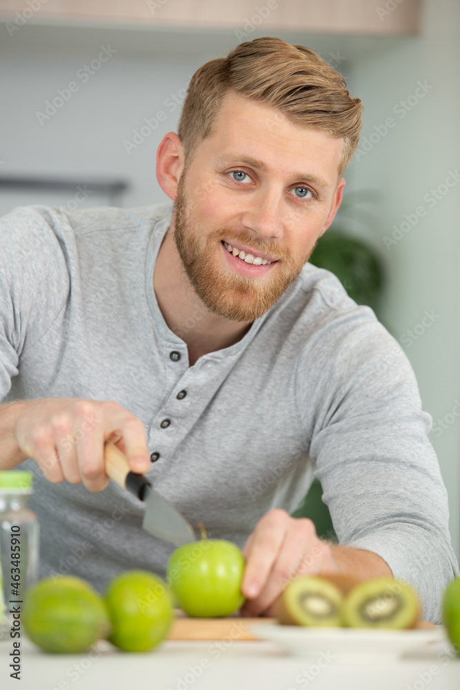 Fototapeta premium happy man cutting organic apples