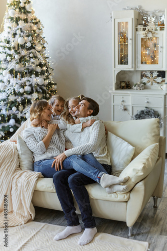 Portrait of beautiful happy family with two children in white sweaters